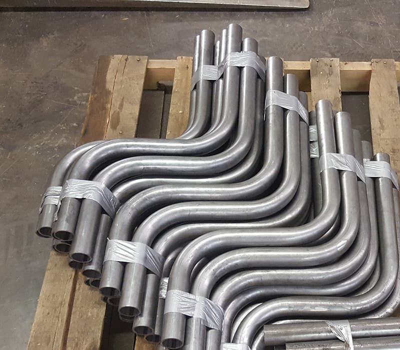CNC bent metal pipes for industrial pipelines.