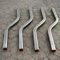 Four precision-bent rectangular tubes with S-curves for use as metal handles.