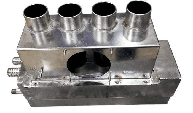 Custom-fabricated stainless steel manifold block with multiple pipe connections for industrial fluid distribution.