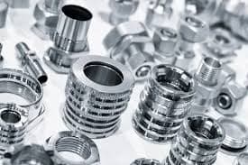 Assorted machined industrial components with precision detailing and polished finish.