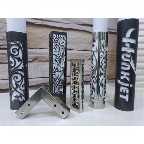Laser-cut decorative metal pipes and square tubes featuring intricate floral and geometric patterns, used for ornamental or architectural applications.