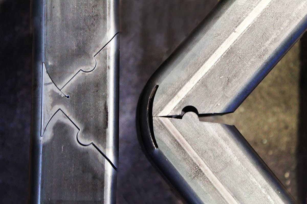 Precision laser-cut joints on metal tubes, designed for seamless bending and accurate assembly.