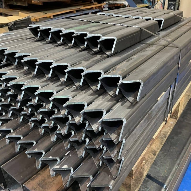 Metal pipes featuring laser-cut slots.