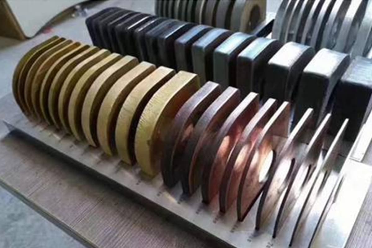 Samples of laser-cut metal plates in varying thicknesses and materials, showcasing cutting precision and edge quality.