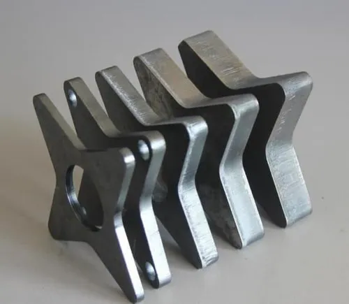 Precision laser-cut sheet metal parts with custom star-shaped profile for industrial applications.