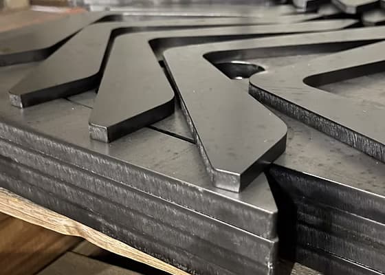 Precision-cut sheet metal counter with clean bends, used in a modern hotel reception for a premium finish.